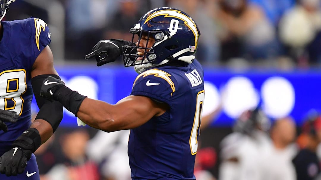 Dec 27, 2025; Inglewood, California, USA;  Los Angeles Chargers linebacker Odafe Oweh (98) and linebacker Daiyan Henley (0) react after a defensive play against the Houston Texans during the second half at SoFi Stadium. Mandatory Credit: Gary A. Vasquez-Imagn Images