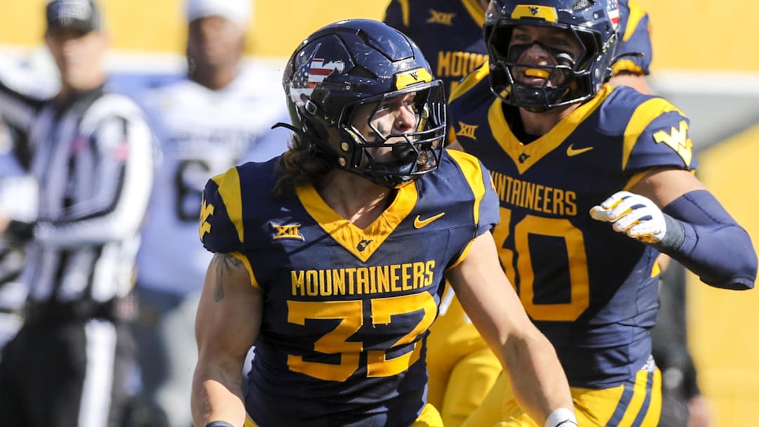 West Virginia Mountaineers linebacker Ben Bogle (32) celebrates after a sack during the first quarter against the Colorado Buffaloes at Milan Puskar Stadium.