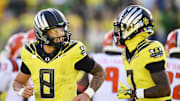 Oct 26, 2024; Eugene, Oregon, USA; Oregon Ducks quarterback Dillon Gabriel (8) celebrates with wide receiver Evan Stewart (7) after scoring a touchdown during the first half against Illinois Fighting Illini at Autzen Stadium. Mandatory Credit: Troy Wayrynen-Imagn Images