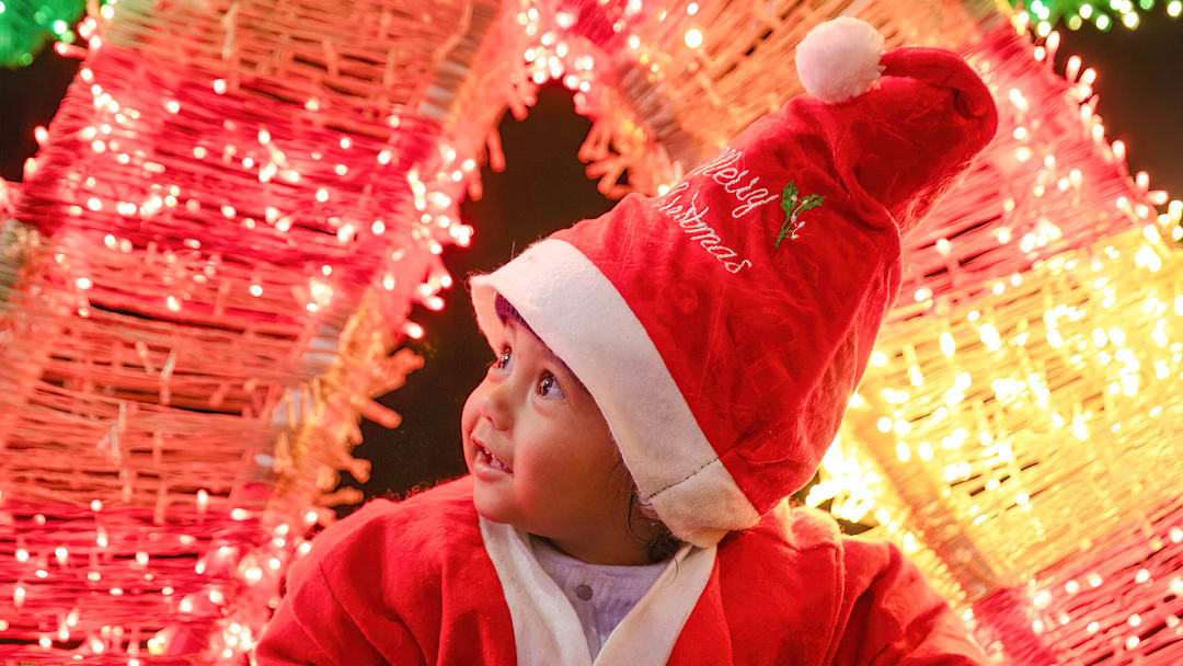 A baby dressed as Santa Claus A baby dressed as Santa Claus