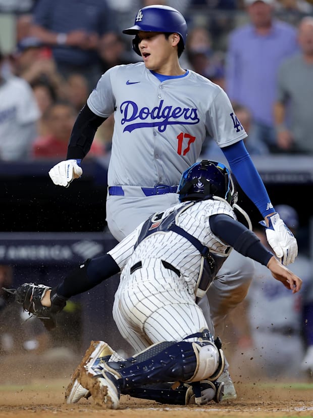 Jun 9, 2024; Bronx, New York, USA; Dodgers’ Shohei Ohtani gets ahead of Jose Trevino’s tag at home to score a run vs. Yankees