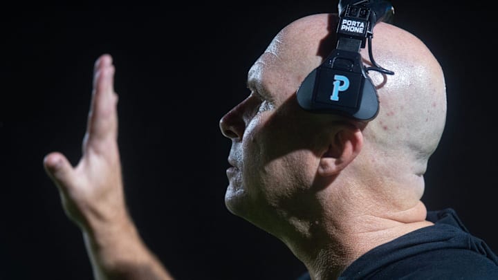 Clinton coach John Carr signals to the Arrows during play against Warren Central in Vicksburg, Miss, Friday, Aug. 30, 2024.