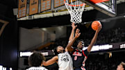 Feb 22, 2025; Nashville, Tennessee, USA; Mississippi Rebels forward Malik Dia (0) shoots over Vanderbilt Commodores forward Devin McGlockton (99) during the second half at Memorial Gymnasium. Mandatory Credit: Steve Roberts-Imagn Images