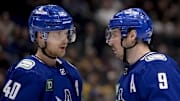 Feb 24, 2024; Vancouver, British Columbia, CAN;  Vancouver Canucks forward Elias Pettersson (40) and forward J.T. Miller (9) talk before a faceoff against the Boston Bruins  during the third period at Rogers Arena. Mandatory Credit: Anne-Marie Sorvin-Imagn Images