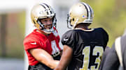 Jul 31, 2023; Metairie, LA, USA; New Orleans Saints wide receiver Michael Thomas (13) and quarterback Derek Carr (4) during training camp at the Ochsner Sports Performance Center. Mandatory Credit: Stephen Lew-Imagn Images