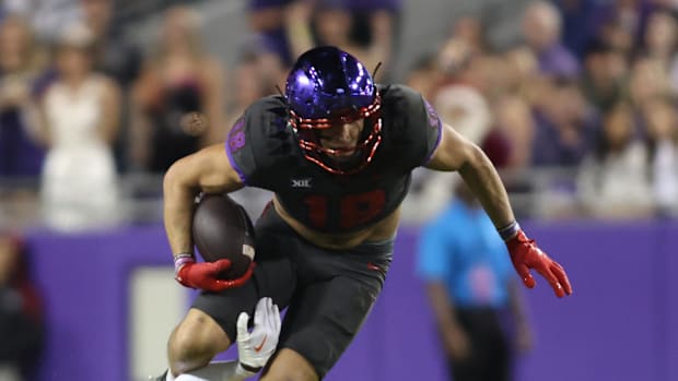 TCU Horned Frogs wide receiver Jack Bech is tackled by Oklahoma State Cowboys safety David Kabongo. 