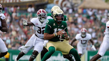 Sep 16, 2023; Tampa, Florida, USA;  South Florida Bulls quarterback Byrum Brown (17) is pressured by Alabama Crimson Tide linebacker Deontae Lawson (32) in the first quarter at Raymond James Stadium. Mandatory Credit: Nathan Ray Seebeck-Imagn Images