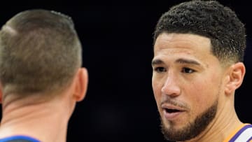 Nov 16, 2025; Phoenix, Arizona, USA; Phoenix Suns guard Devin Booker (1) reacts during a conversation with the referee during the second half of a game against the Atlanta Hawks at Mortgage Matchup Center. Mandatory Credit: Allan Henry-Imagn Images