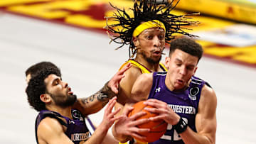 Minnesota Gophers forward Brandon Johnson (23) and Northwestern Wildcats forward Pete Nance (22) and guard Boo Buie (0) fight for the ball during the first half Feb 25, 2021; Minneapolis, Minnesota, USA;  at Williams Arena. Mandatory Credit: Harrison Barden-Imagn Images