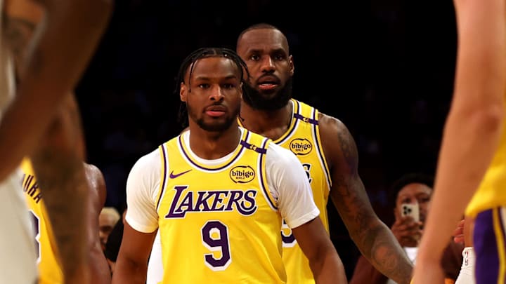 Oct 22, 2024; Los Angeles, California, USA; Los Angeles Lakers forward LeBron James (23) checks into the game with his son, guard Bronny James (9) during the second quarter against the Minnesota Timberwolves at Crypto.com Arena. This marked the first time in NBA history that a father and son played together. Mandatory Credit: Jason Parkhurst-Imagn Images Oct 22, 2024; Los Angeles, California, USA; Los Angeles Lakers forward LeBron James (23) checks into the game with his son, guard Bronny James (9) during the second quarter against the Minnesota Timberwolves at Crypto.com Arena. This marked the first time in NBA history that a father and son played together. Mandatory Credit: Jason Parkhurst-Imagn Images