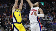 Oct 23, 2024; Detroit, Michigan, USA;  Indiana Pacers guard T.J. McConnell (9) shoots on Detroit Pistons guard Cade Cunningham (2) in the second half at Little Caesars Arena. Mandatory Credit: Rick Osentoski-Imagn Images