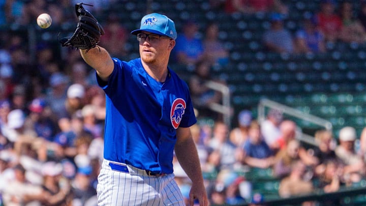 Feb 27, 2025; Mesa, Arizona, USA; Chicago Cubs pitcher Jordan Wicks (36) reaches out to grab ball while on the mound in the first inning during a spring training game against the Los Angeles Angels at Sloan Park. Mandatory Credit: Allan Henry-Imagn Images