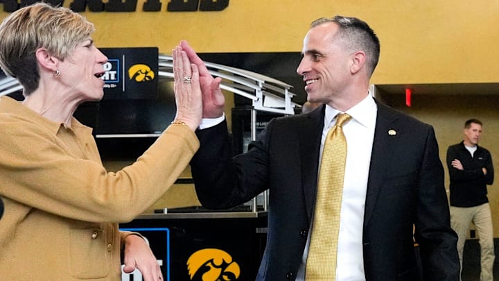 Iowa head men's basketball coach Ben McCollum high-fives Jan Jensen, the head women's basketball coach, after his introductory press conference Tuesday, March 25, 2025 at Carver-Hawkeye Arena in Iowa City, Iowa.