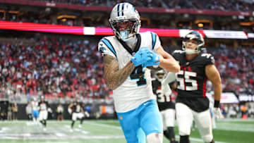 Nov 16, 2025; Atlanta, Georgia, USA; Carolina Panthers wide receiver Tetairoa McMillan (4) catches the ball for a touchdown in the fourth quarter against the Atlanta Falcons at Mercedes-Benz Stadium. 