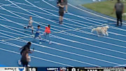 A dog races against children on the track at the 2024 Bahamas Bowl.