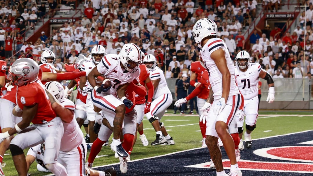 Aug 31, 2024; Tucson, Arizona, USA; Arizona Wildcats running back Quail Conley (7) runs a touchdown during the third quarter at Arizona Stadium. 