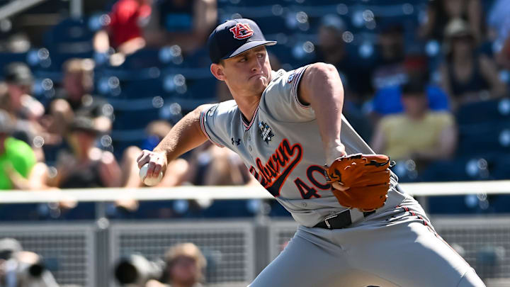Jun 20, 2022; Omaha, NE, USA;  Auburn Tigers pitcher Blake Burkhalter (40) pitches against the Stanford Cardinal in the ninth inning at Charles Schwab Field. Mandatory Credit: Steven Branscombe-Imagn Images