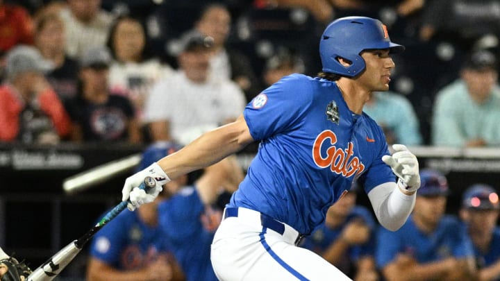 Jun 19, 2024; Omaha, NE, USA;  Florida Gators first baseman Jac Caglianone (14) singles in the Texas A&M Aggies during the eighth inning at Charles Schwab Field Omaha. Mandatory Credit: Steven Branscombe-USA TODAY Sports