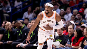 Apr 5, 2024; New Orleans, Louisiana, USA; San Antonio Spurs guard Devonte' Graham (4) reacts to making a 3-point basket against the New Orleans Pelicans during the first half at Smoothie King Center. 