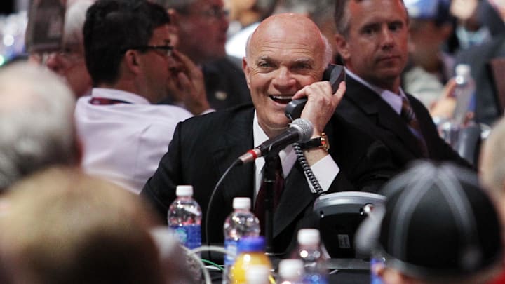 Jun 30, 2013; Newark, NJ, USA; New Jersey Devils general manager Lou Lamoriello speaks on the phone during the 2013 NHL Draft at the Prudential Center. Mandatory Credit: Ed Mulholland-Imagn Images