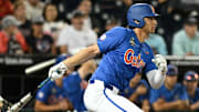 Jun 19, 2024; Omaha, NE, USA;  Florida Gators first baseman Jac Caglianone (14) singles in the Texas A&M Aggies during the eighth inning at Charles Schwab Field Omaha. Mandatory Credit: Steven Branscombe-Imagn Images