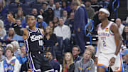 Oct 28, 2025; Oklahoma City, Oklahoma, USA; Sacramento Kings guard Russell Westbrook (18) gestures after scoring a three point basket against Oklahoma City Thunder guard Shai Gilgeous-Alexander (2) during the first quarter at Paycom Center. Mandatory Credit: Alonzo Adams-Imagn Images