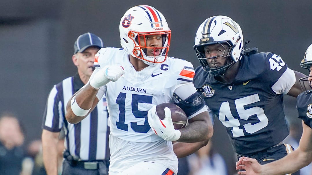 Auburn defensive end Keldric Faulk faces a tough one-on-one battle against Alabama's Kadyn Procter.