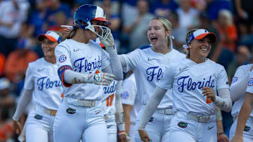 Florida outfielder Taylor Shumaker (21), left, celebrates a home run during an NCAA softball game at Katie Seashole Pressly Stadium in Gainesville, FL on Friday, April 18, 2025. Florida won 12-4 in the fifth inning. [Alan Youngblood/Gainesville Sun