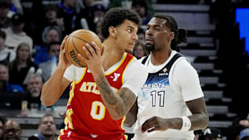 Jan 27, 2025; Minneapolis, Minnesota, USA; Atlanta Hawks forward Dom Barlow (0) posts up as Minnesota Timberwolves center Naz Reid (11) defends him in the third quarter at Target Center. Mandatory Credit: Bruce Kluckhohn-Imagn Images