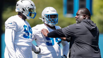 Detroit Lions defensive tackle Brodric Martin (99) talks to defensive line coach Terrell Williams 