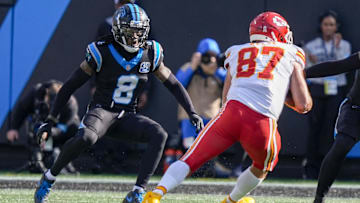 Nov 24, 2024; Charlotte, North Carolina, USA; Kansas City Chiefs tight end Travis Kelce (87) tries to elude Carolina Panthers cornerback Jaycee Horn (8) during the second quarter at Bank of America Stadium. Mandatory Credit: Jim Dedmon-Imagn Images