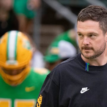 Oregon coach dan lanning ducks dante moore iowa hawkeyes kinnick stadium wave hostile fans playoff upset big ten road game schedule rankings snub