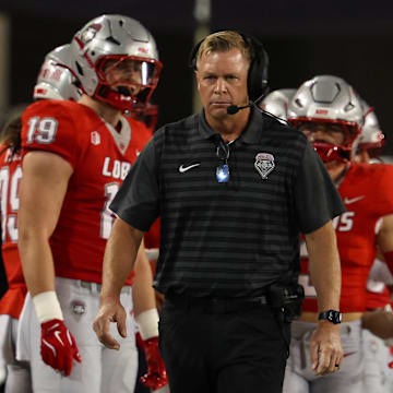 New Mexico head coach Bronco Mendenhall walks down the sideline at the beginning of the game at Arizona Stadium. 