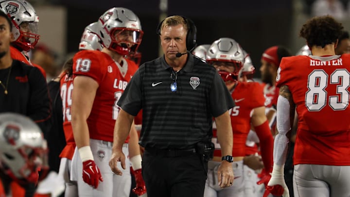 New Mexico head coach Bronco Mendenhall walks down the sideline at the beginning of the game at Arizona Stadium. 