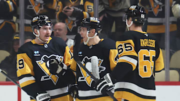 Mar 13, 2025; Pittsburgh, Pennsylvania, USA;  Pittsburgh Penguins center Connor Dewar (19) celebrates his goal with center Blake Lizotte (middle) and defenseman Erik Karlsson (65) against the St. Louis Blues during the second period at PPG Paints Arena. Mandatory Credit: Charles LeClaire-Imagn Images