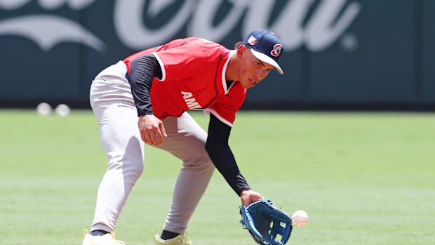 Detroit Tigers minor leaguer takes ground balls at the Futures Game wearing a red jersey and blue hat.