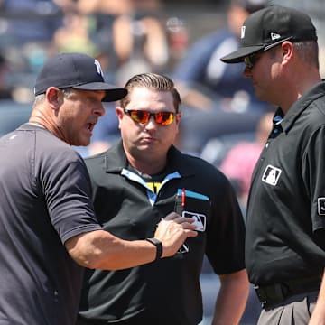 Bronx, New York, USA; New York Yankees manager Aaron Boone (17) argues with umpires Derek Thomas (53) and Jordan Baker (71) in the third inning against the Houston Astros at Yankee Stadium.