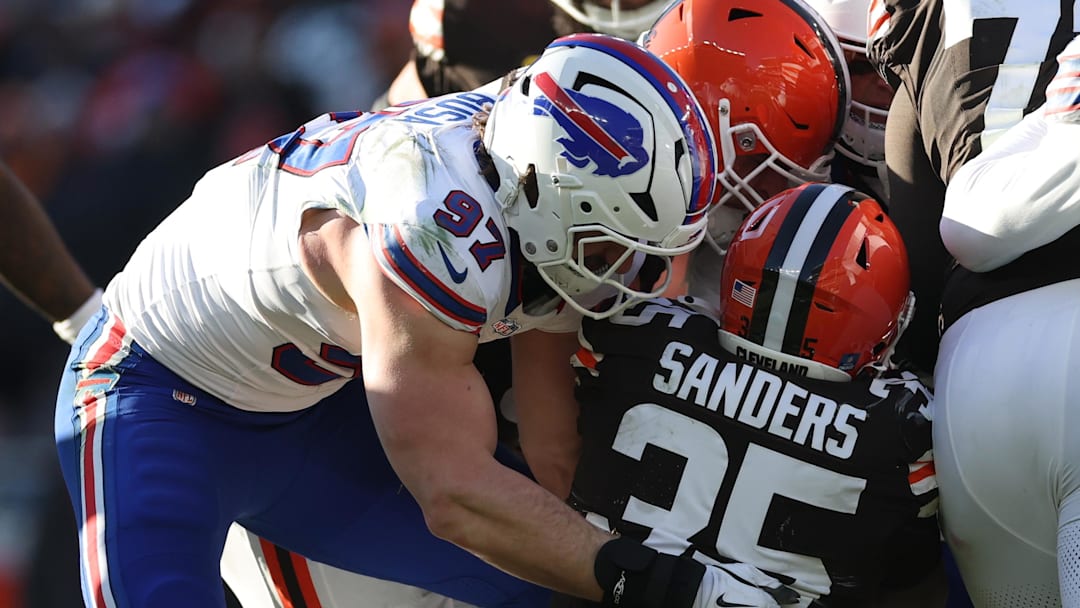Dec 21, 2025; Cleveland, Ohio, USA;  Cleveland Browns running back Raheim Sanders (35) is tackled by Buffalo Bills defensive end Joey Bosa (97) during the second half at Huntington Bank Field. Mandatory Credit: Scott Galvin-Imagn Images