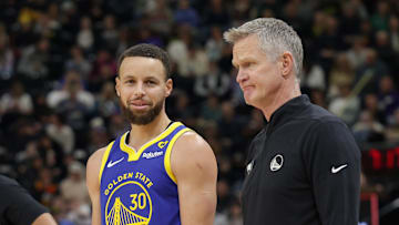Feb 15, 2024; Salt Lake City, Utah, USA; Golden State Warriors guard Stephen Curry (30) and head coach Steve Kerr talk on the sideline during the first quarter against the Utah Jazz at Delta Center. Mandatory Credit: Chris Nicoll-Imagn Images