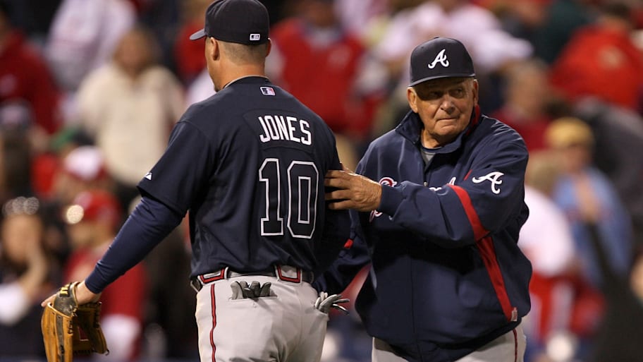 Bobby Cox, right, congratulates Chipper Jones after a Braves win.