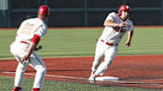 Indiana's Hogan Denny rounds third base as head coach Jeff Mercer keeps an eye on the relay throws during the Hoosiers' 8-0 win over Purdue on May 9, 2025.