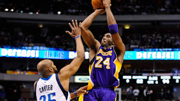 Mar 21, 2012; Dallas, TX, USA; Los Angeles Lakers shooting guard Kobe Bryant (24) makes a jump shot over Dallas Mavericks shooting guard Vince Carter (25) during the game at the American Airlines Center. The Lakers defeated the Mavericks 109-93. Mandatory Credit: Jerome Miron-Imagn Images
