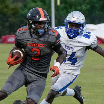 Spruce Creek's Tony Kinsler (2) turns the corner for a TD run during a game with Deltona at Spruce