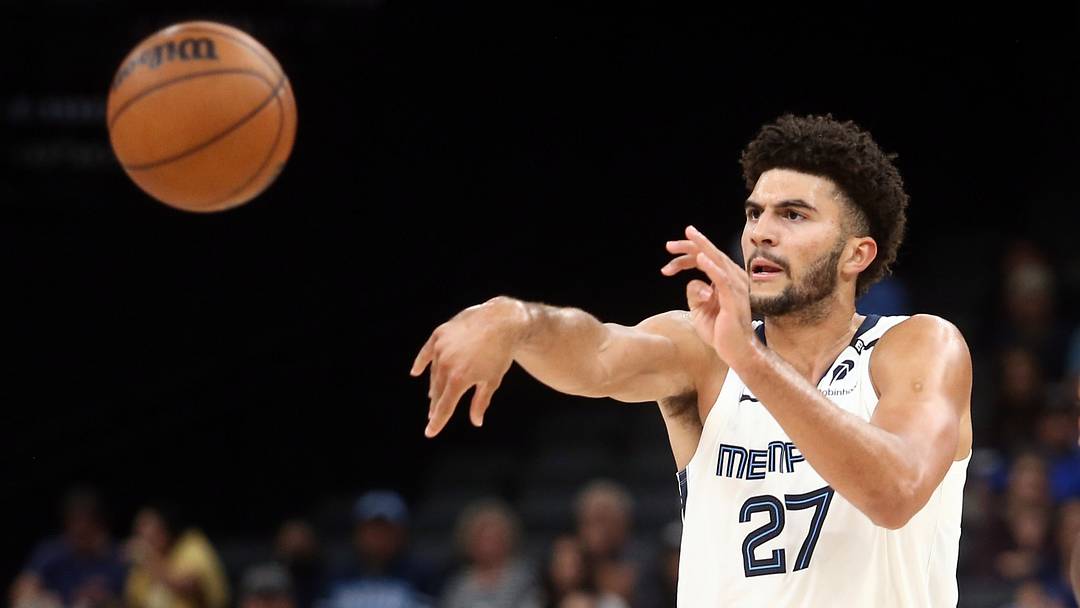 Oct 7, 2026; Memphis, Tennessee, USA;  Memphis Grizzlies forward Cameron Boozer (27) passes the ball as Orlando Magic forward Jamal Cain (8) defends during the third quarter at FedExForum.  Mandatory Credit: Petre Thomas-Imagn Images
