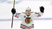Oct 10, 2023; Pittsburgh, Pennsylvania, USA; Chicago Blackhawks center Connor Bedard (98) reacts to a goal by center Ryan Donato (not pictured) against the Pittsburgh Penguins during the second period at the PPG Paints Arena. Beard assisted on the goal to record his first NHL point in his league debut. Mandatory Credit: Charles LeClaire-Imagn Images