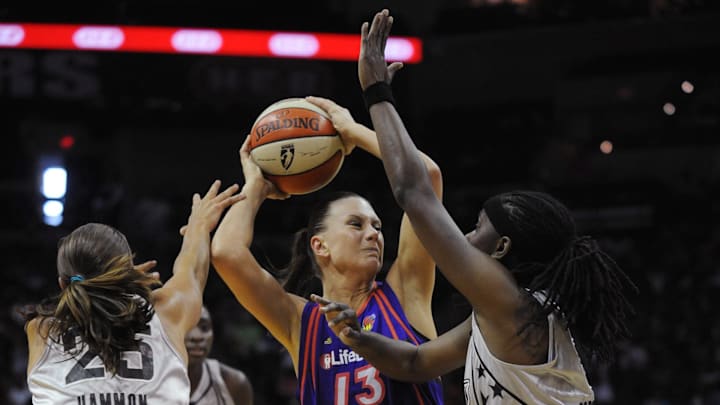 August 28, 2010; San Antonio, TX, USA; Phoenix Mercury forward Penny Taylor (13) controls the ball under pressure from San Antonio Silver Stars guards Becky Hammon (25) and Roneeka Hodges (right) during the second half at the AT&T Center. Phoenix beat San Antonio 92-73. Mandatory Credit: Brendan Maloney-Imagn Images