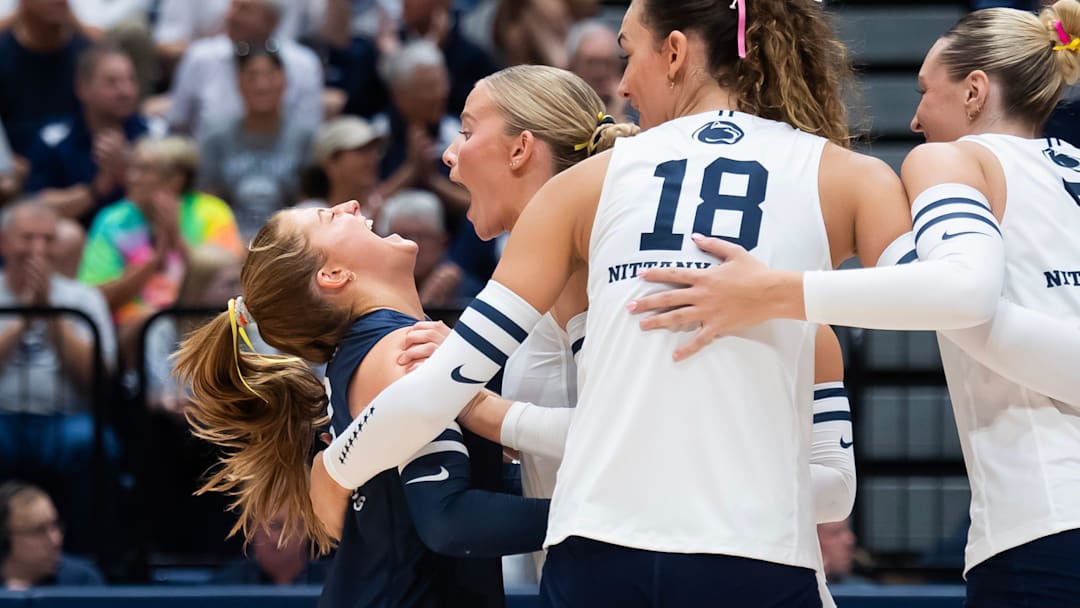 Penn State libero Gillian Grimes, left, celebrates a point with Emmi Sellman