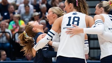 Penn State libero Gillian Grimes, left, celebrates a point with Emmi Sellman