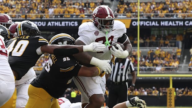 Alabama Crimson Tide offensive lineman Kadyn Proctor (74) runs with the football and is stopped short of the end zone.