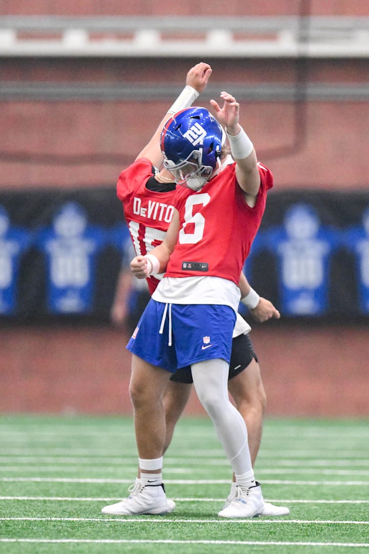 New York Giants quarterbacks Tommy DeVito and Jaxson Dart interact during minicamp.
